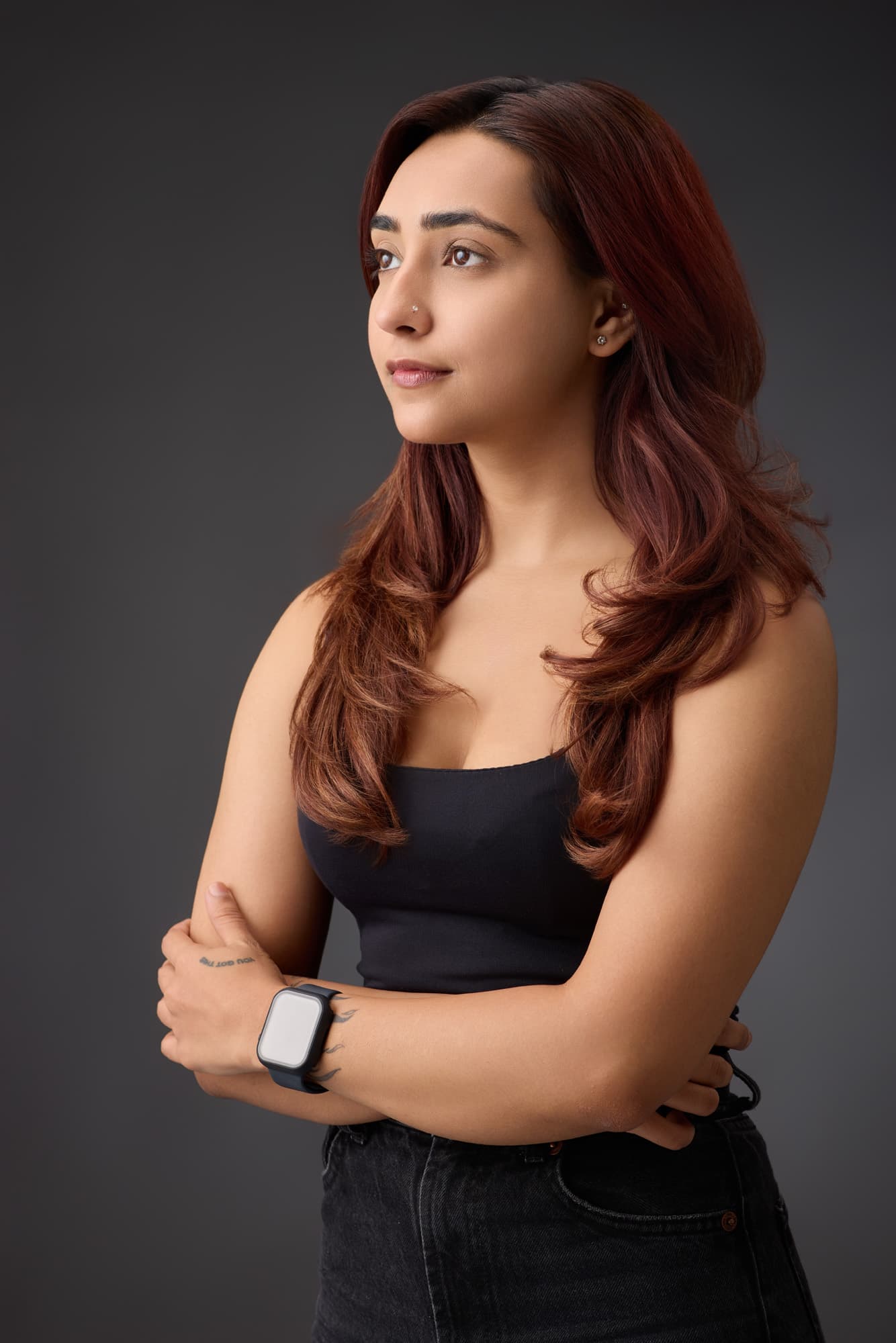 Professional with arms crossed on a dark studio backdrop — business portrait photography by Imagesque, Dubai