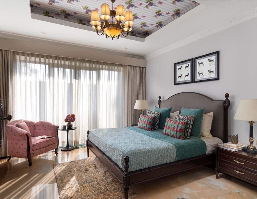 Bedroom with a decorative ceiling and chandelier — hospitality photography by Imagesque, Dubai