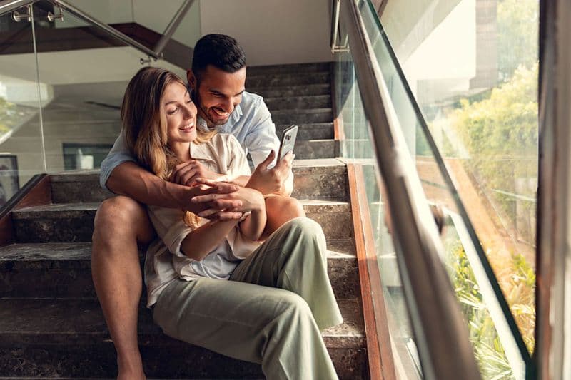 Couple relaxing together on a staircase at home — lifestyle photography